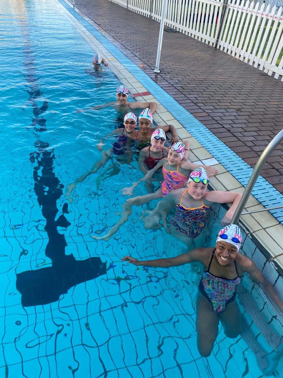 Squad swimmers at the poolside at Precision Aquatics